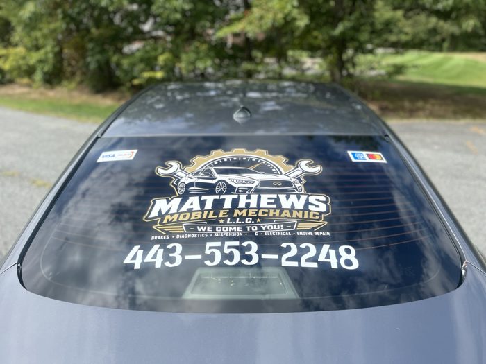 Matthews Mobile Mechanic logo and phone number on the Infiniti rear window