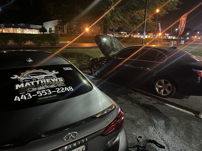 Branded Matthews Mobile Mechanic Infiniti parked beside tools at night
